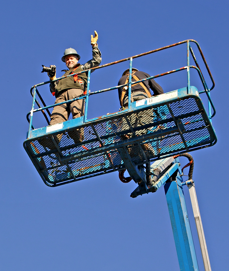 Mark Lindquist in Boom Lift photographing during the Blakely Burl Tree Project.  Photo by Terry Martin.